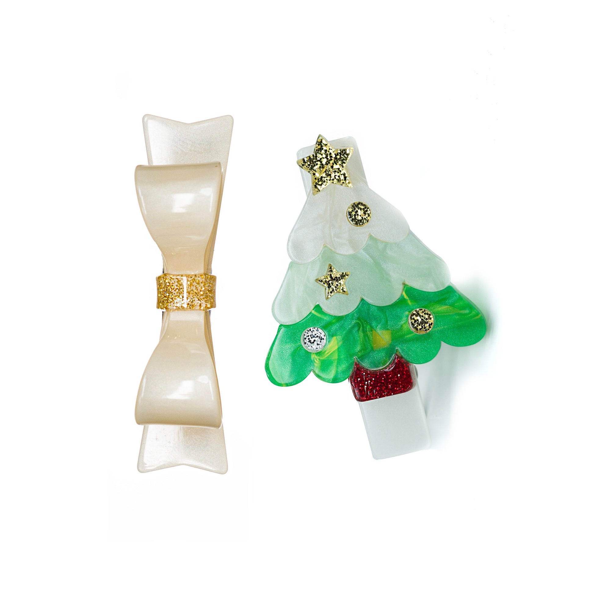 Hair clip set of two different charms. One is a green pearlized Christmas tree with gold glitter  decorations and the other one is a cream pearlized bow.  